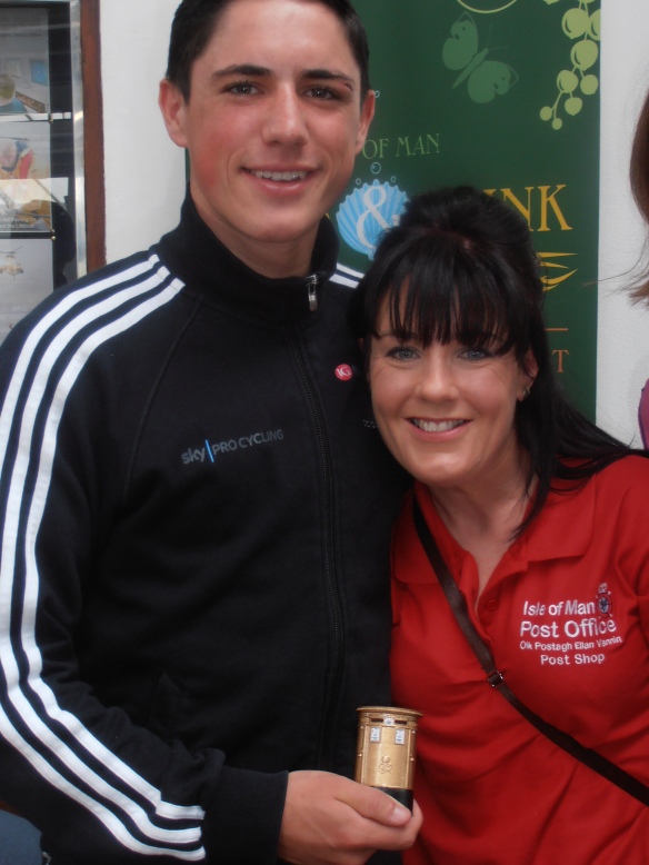 Manx Olympic Gold Medalist Peter Kennaugh and Mirella Annis, marketing assistant, Isle of Man Stamps & Coins